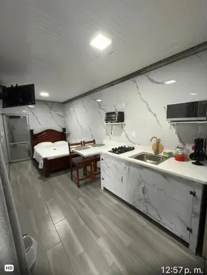 a room with a kitchen and a bedroom with a bed at Apartamento doña Lety in Fortuna