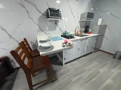 a small kitchen with a table and a sink at Apartamento doña Lety in Fortuna
