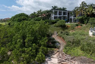 an aerial view of a house on a hill with trees at Casa Ohana - 5 BR Ocean Front Home in Playa Negra, CRC in Playa Negra