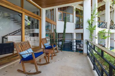 a porch with two chairs on a house at Casa Ohana - 5 BR Ocean Front Home in Playa Negra, CRC in Playa Negra
