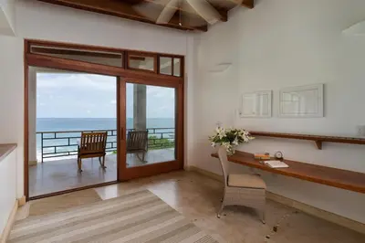 a home office with a desk and a view of the ocean at Casa Ohana - 5 BR Ocean Front Home in Playa Negra, CRC in Playa Negra