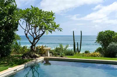 a swimming pool with the ocean in the background at Casa Ohana - 5 BR Ocean Front Home in Playa Negra, CRC in Playa Negra