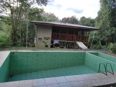 a house with a swimming pool in front of it at CASA CON PISCINA Montañas de San Ramón in San Ramón