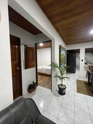 a living room with a couch and a bedroom at Downtown volcano House in Fortuna