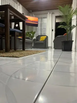 a living room with a white tiled floor at Downtown volcano House in Fortuna