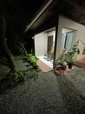 a house at night with a hose on the ground at Downtown volcano House in Fortuna