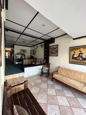 a living room with a couch and a table at Hotel Pacande B&B in Alajuela City