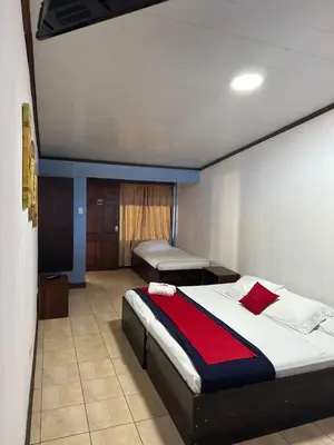 a bedroom with two beds in a room at Hotel Pacande B&B in Alajuela City