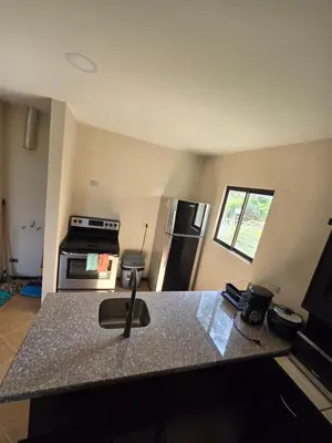 a kitchen with a granite counter top and a stove at Oceanic vista in Coco
