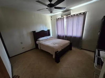 a bedroom with a bed and a ceiling fan at Oceanic vista in Coco