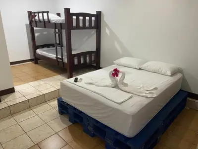 a bed with a swan decoration on top of it at La Hacienda Rooms & Food in Jacó