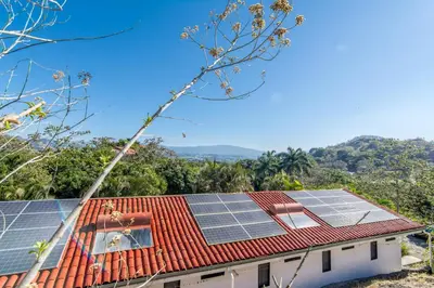 a house with solar panels on the roof at Hotel Colinas del Sol in Atenas