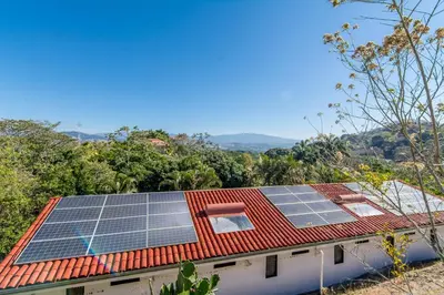 a house with solar panels on the roof at Hotel Colinas del Sol in Atenas