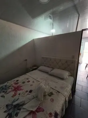 a bedroom with a bed with a flower patterned blanket at Apartamentos Novoa in San José