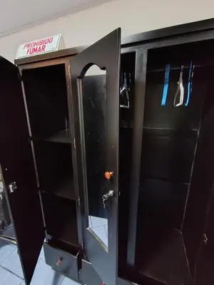 a black cabinet with a glass door with a mirror at Apartamentos Novoa in San José