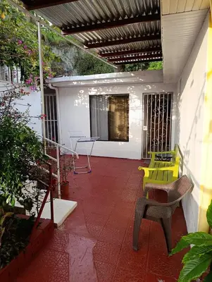 a patio with a yellow bench and a table at Apartamentos Novoa in San José