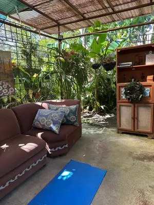 a living room with a couch and a table at Yellow House in Huacalillo