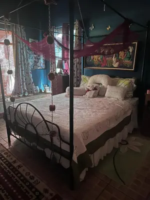 a bedroom with a bed with a canopy at Yellow House in Huacalillo