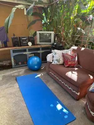 a living room with a couch and a blue rug at Yellow House in Huacalillo