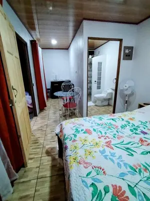 a bedroom with a bed and a table and a bathroom at Cabana Castaña in Marsella