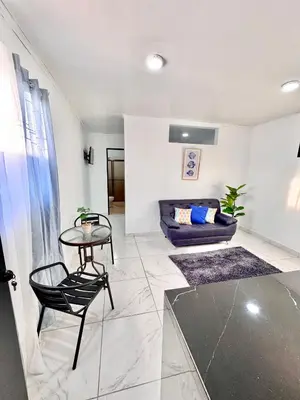 a living room with a table and a couch at Global House Apartamento 2 in Alajuela City