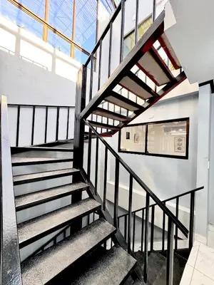 a staircase in a building with a glass ceiling at Global House Apartamento 2 in Alajuela City