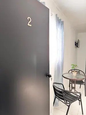 a room with a table and chairs and a door at Global House Apartamento 2 in Alajuela City