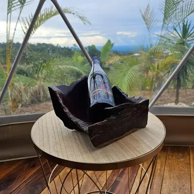 a table in front of a window with a bottle on it at Love Glamping Dome in El Hogar