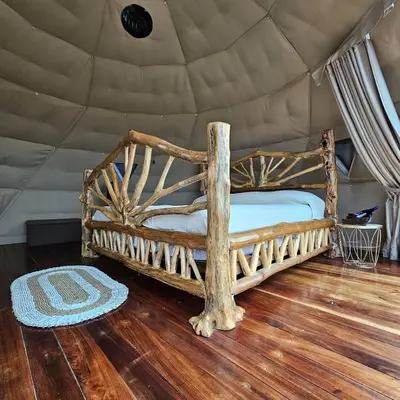 a bedroom with a bed in a tent at Love Glamping Dome in El Hogar