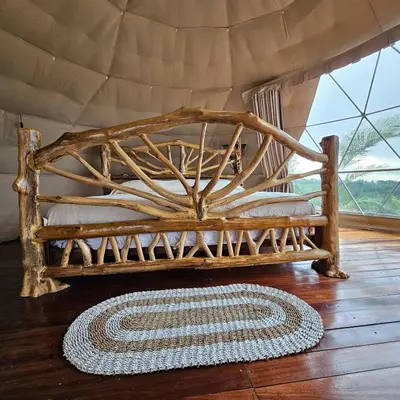 a wooden bench sitting on a wooden floor with a rug at Love Glamping Dome in El Hogar