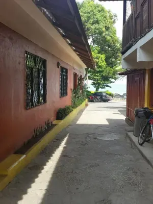 a sidewalk next to a building with a bike parked next to it at Hotel Cabinas Mar Y Cielo in Montezuma