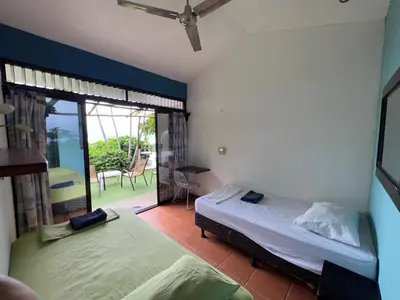 a bedroom with two beds and a balcony at Blue Dream Kite Boarding Resort Costa Rica in Puerto Soley