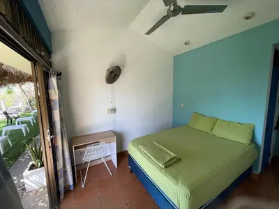 a small bedroom with a bed in a room at Blue Dream Kite Boarding Resort Costa Rica in Puerto Soley