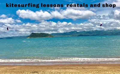 two kites flying over the water on a beach at Blue Dream Kite Boarding Resort Costa Rica in Puerto Soley