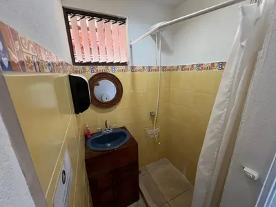 a small bathroom with a sink and a mirror at Blue Dream Kite Boarding Resort Costa Rica in Puerto Soley