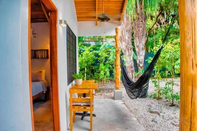 a room with a hammock and a bedroom with a bed at Casa Bonita - 5br With Pool Walk To Beach! in Nosara
