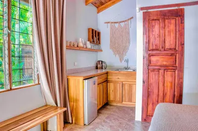 a kitchen with a wooden door and a sink at Casa Bonita - 5br With Pool Walk To Beach! in Nosara