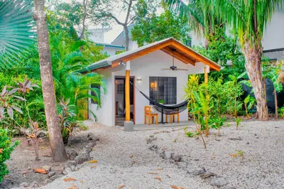 a house with a hammock in front of it at Casa Bonita - 5br With Pool Walk To Beach! in Nosara