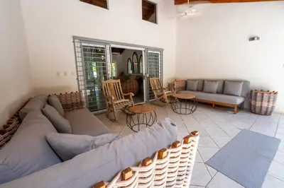 a living room with a couch and a table and chairs at Casa Bonita - 5br With Pool Walk To Beach! in Nosara