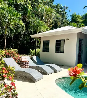 a patio with chairs and a pool in front of a house at Casa Bonita - 5br With Pool Walk To Beach! in Nosara