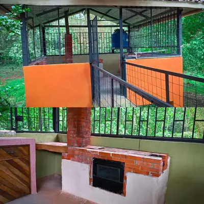 a house with a fireplace and a balcony at Casa corazón verde in Jiménez