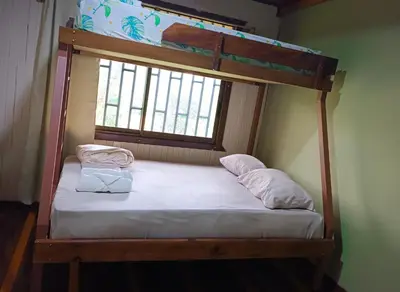 a bunk bed in a room with a window at Casa corazón verde in Jiménez