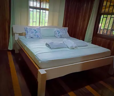 a bed with blue pillows and a mattress at Casa corazón verde in Jiménez