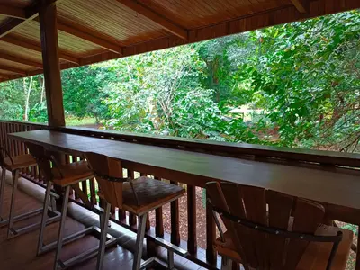 a wooden table and chairs on a porch at Casa corazón verde in Jiménez