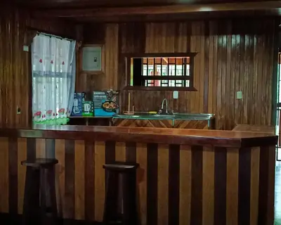 a kitchen with a bar with a sink and a window at Casa corazón verde in Jiménez