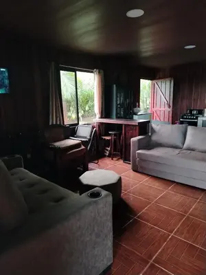 a living room with a couch and a table at Villa Guayacanes Forest in Chachagua