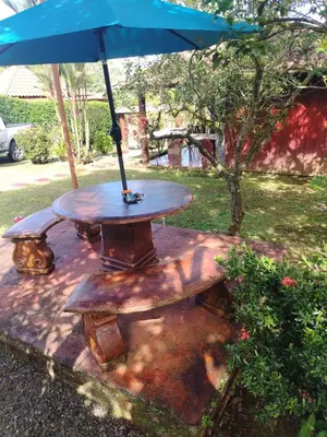a picnic table with an umbrella on top of it at Villa Guayacanes Forest in Chachagua