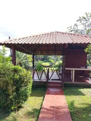 a wooden pavilion with a picnic table in the grass at Villa Guayacanes Forest in Chachagua