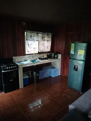 a kitchen with a refrigerator and a sink and a stove at Villa Guayacanes Forest in Chachagua