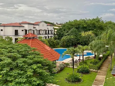 an aerial view of a resort with a swimming pool at Palmas Resort De Tamarindo Serenity Gem in Villarreal